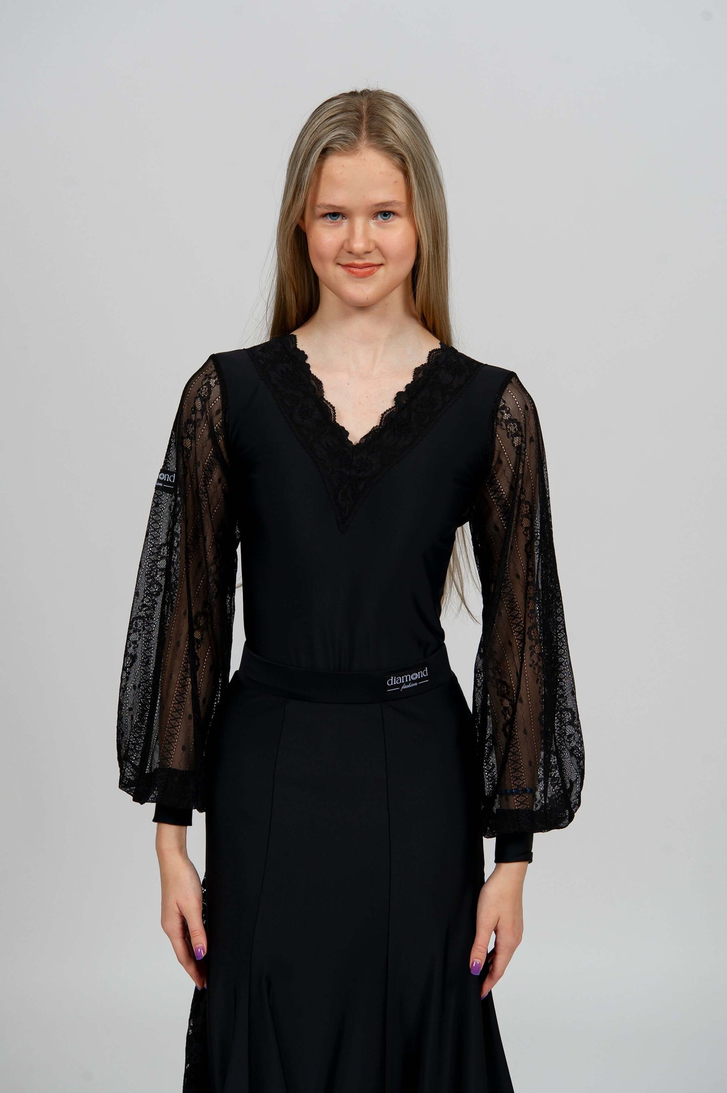 Elegant black Latin dance bodysuit with lace sleeves and deep open back — ideal for ballroom and Latin dance performance.