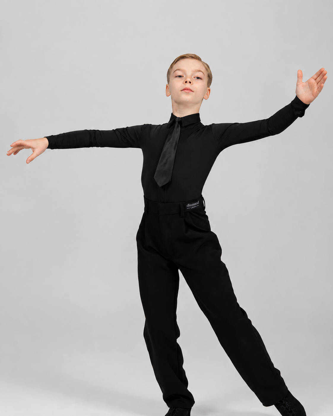 Boy wearing a black Standard Ballroom dance shirt bodysuit with black tie, designed for competitions and dance training