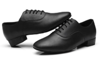 Black men’s ballroom dance shoes for Latin and Standard with lace-up design and low heel on a light background
