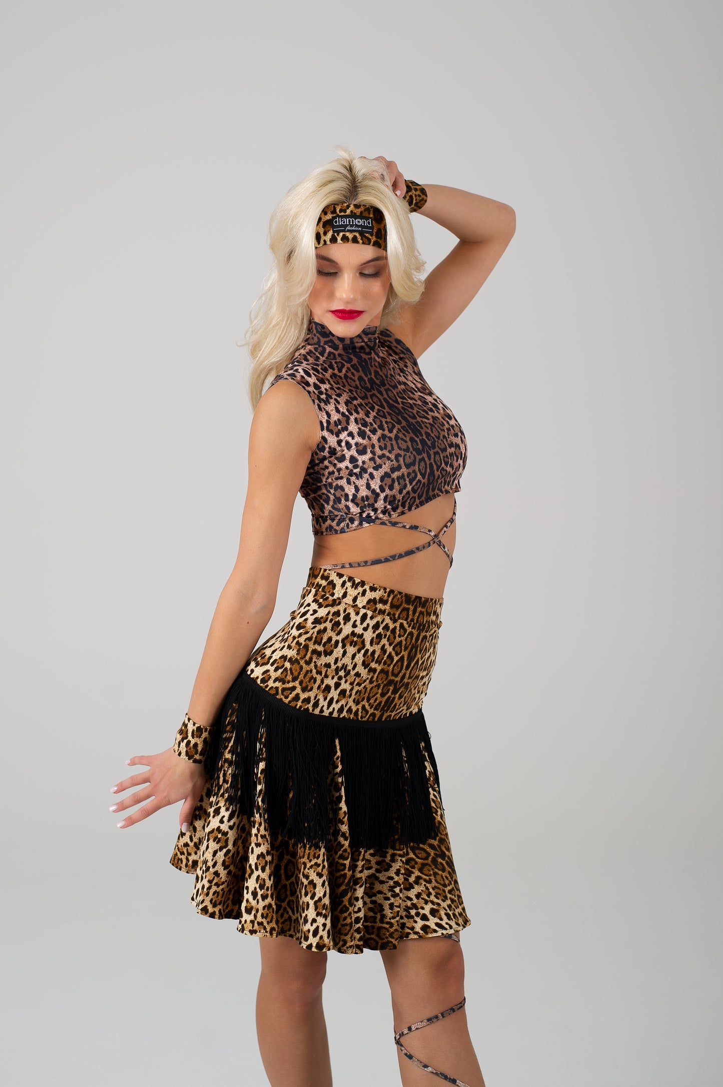 Diamond Fashion Motion Luxe Latin dancewear set in LEOPARD print – two female dancers in sleeveless fringe dresses performing ballroom and Latin practice moves.