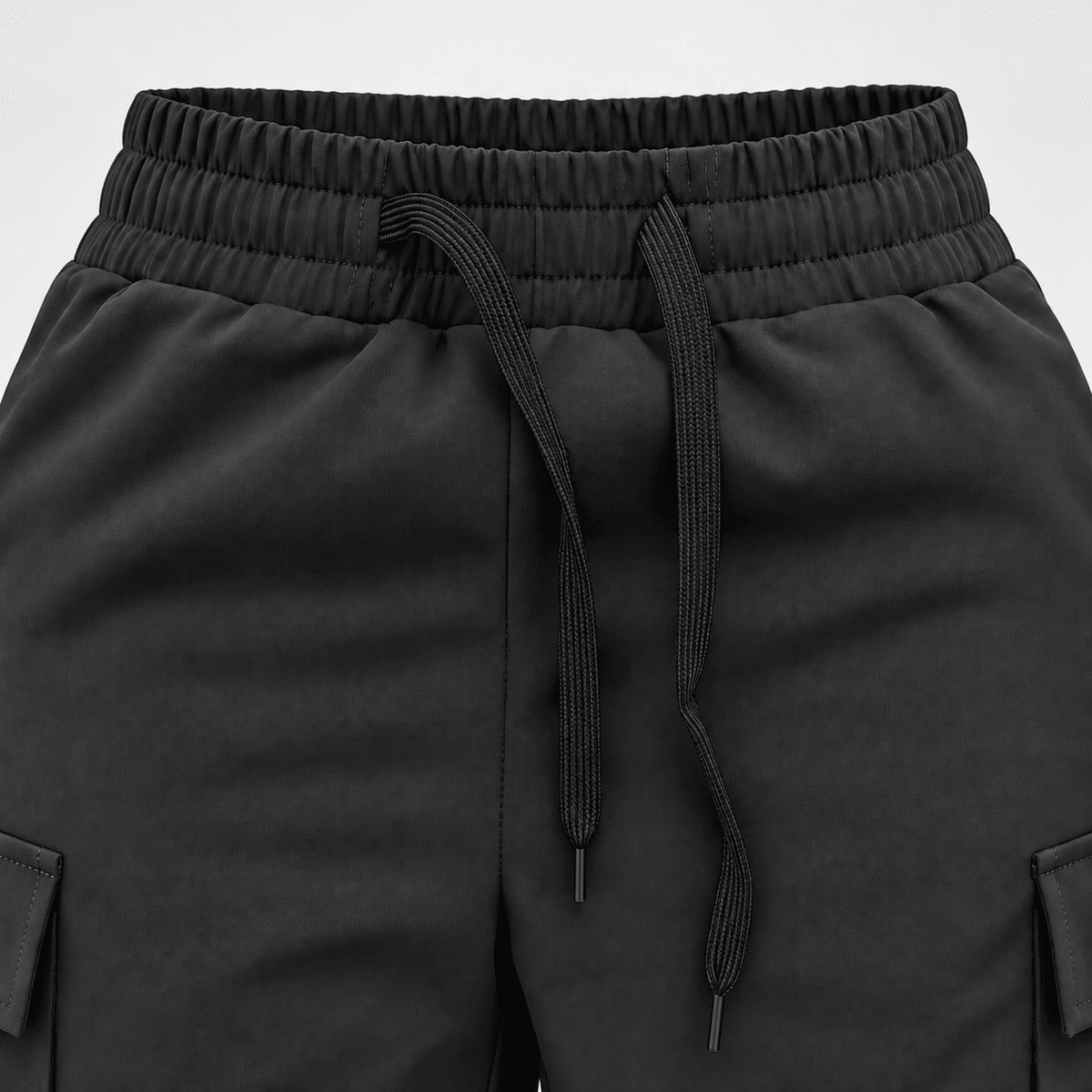 Close-up of Diamond Fashion black dance trousers showing the elasticated waistband, adjustable drawstring and side pockets.