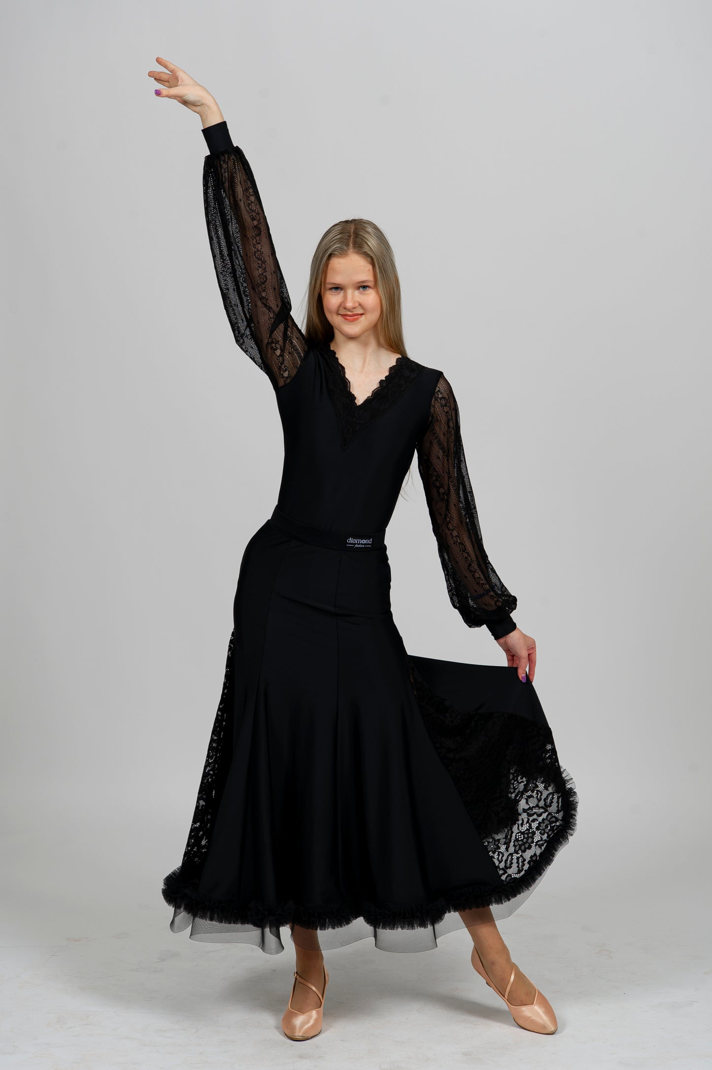 Elegant black Latin dance bodysuit with lace sleeves and deep open back — ideal for ballroom and Latin dance performance.