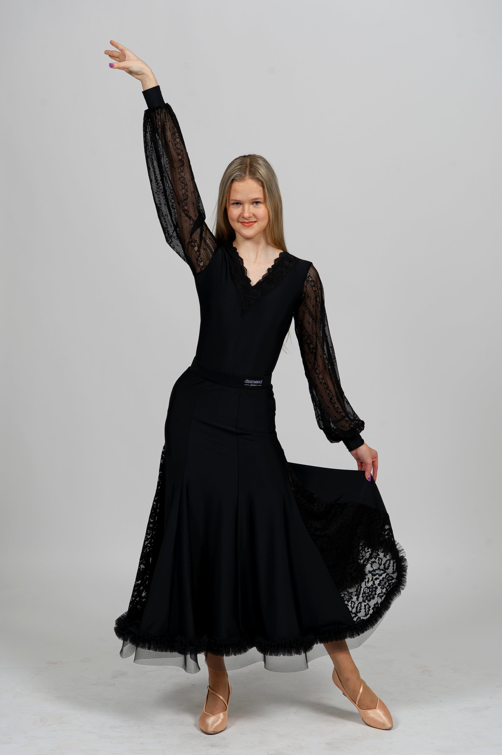 Elegant black Latin dance bodysuit with lace sleeves and deep open back — ideal for ballroom and Latin dance performance.