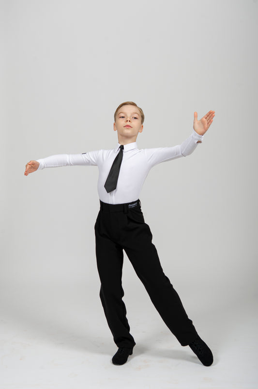 Boys ballroom dance pants worn by a young dancer performing in a white shirt and black tie.