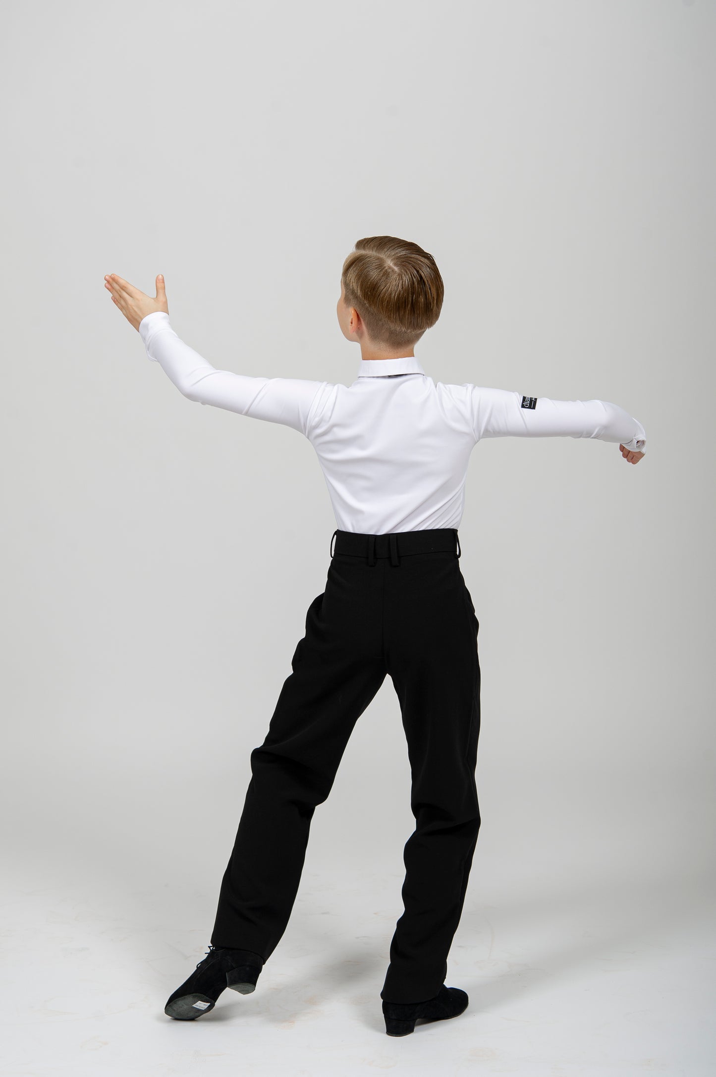 Boys ballroom dance pants on a young dancer, showcasing elegance and style for competition and practice.