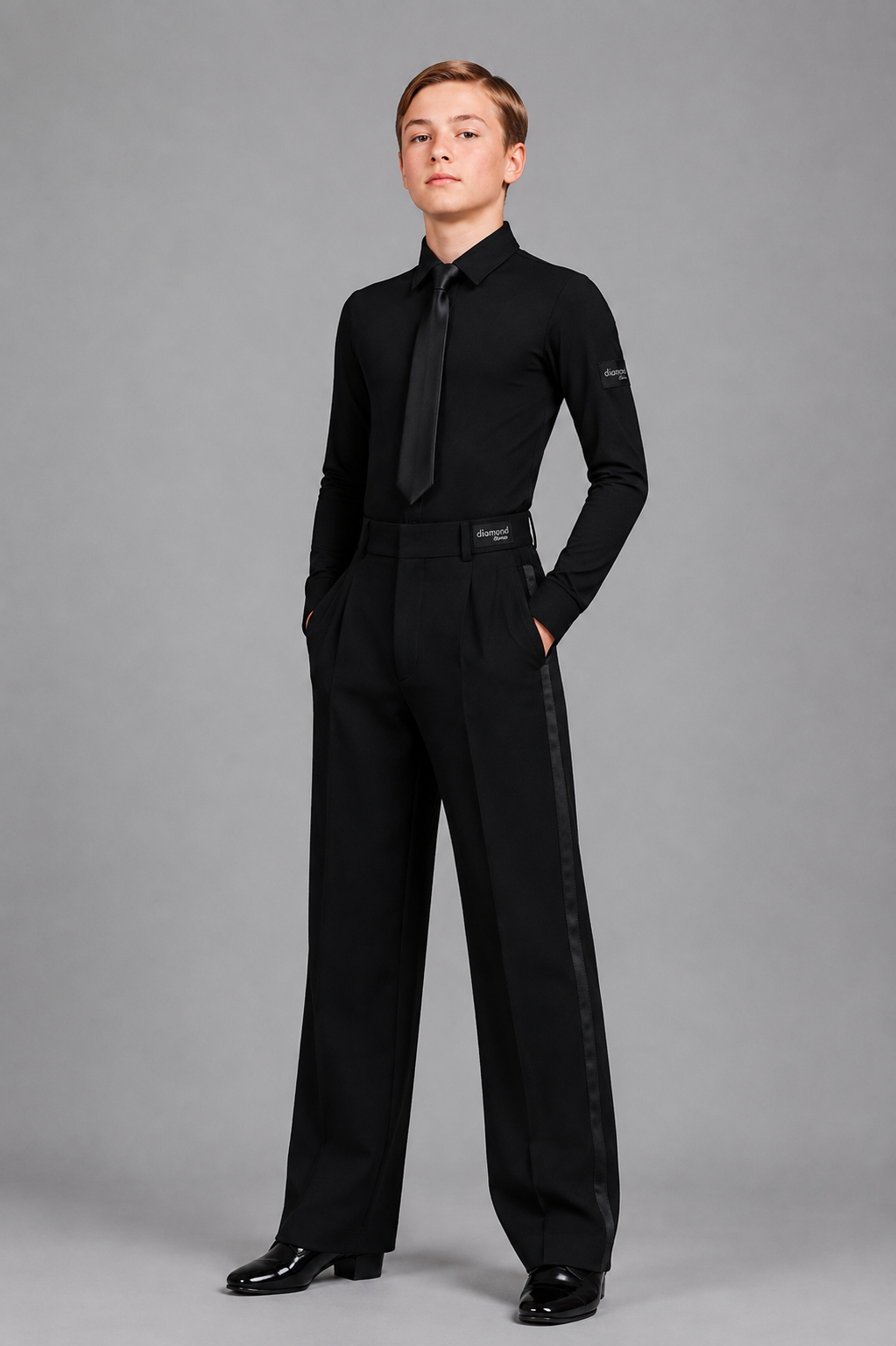 Boy’s black ballroom dance competition outfit with long-sleeve dance shirt, black tie and professional ballroom trousers by Diamond Fashion