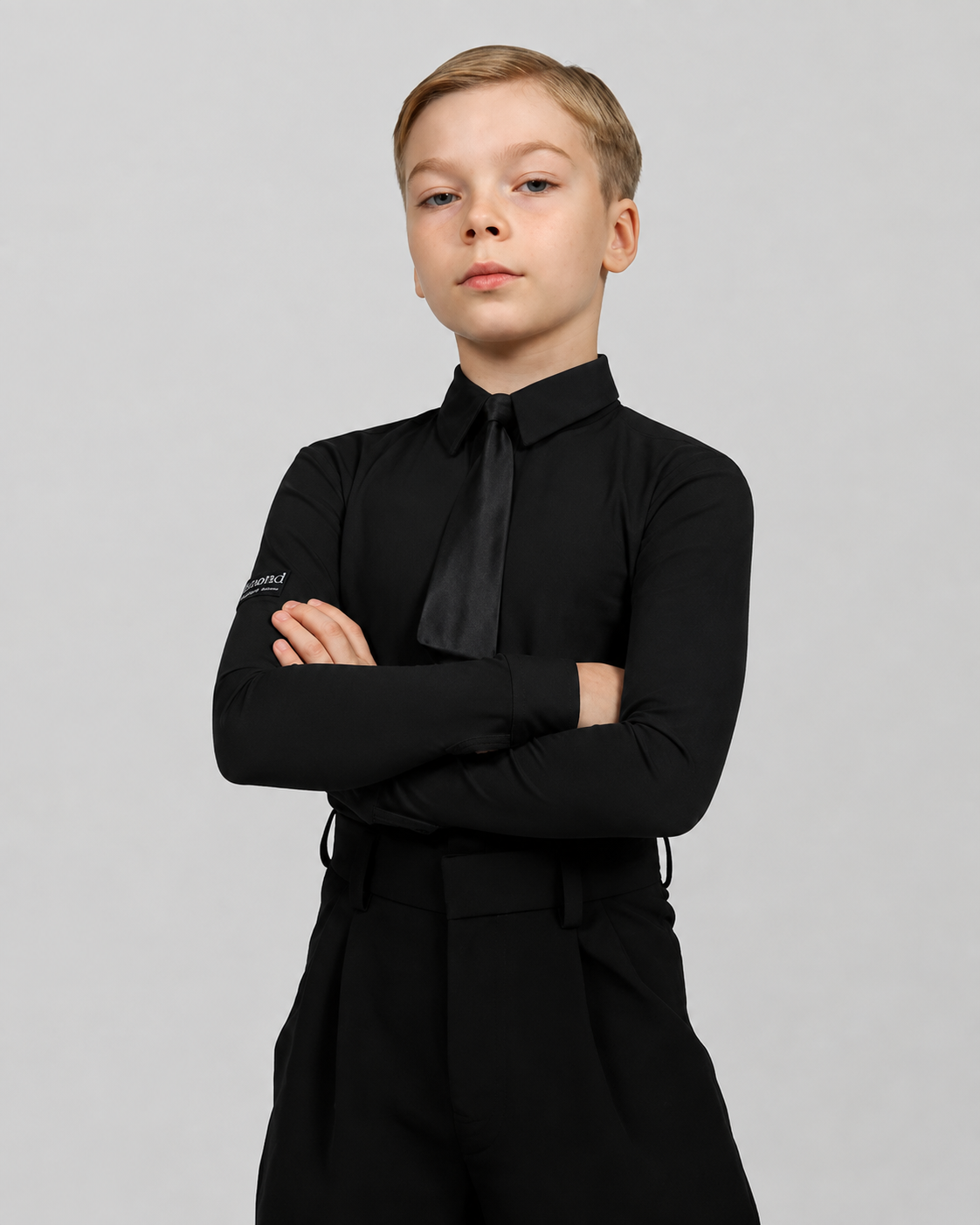 Boy wearing a black Standard Ballroom dance shirt bodysuit with black tie, designed for competitions and dance training