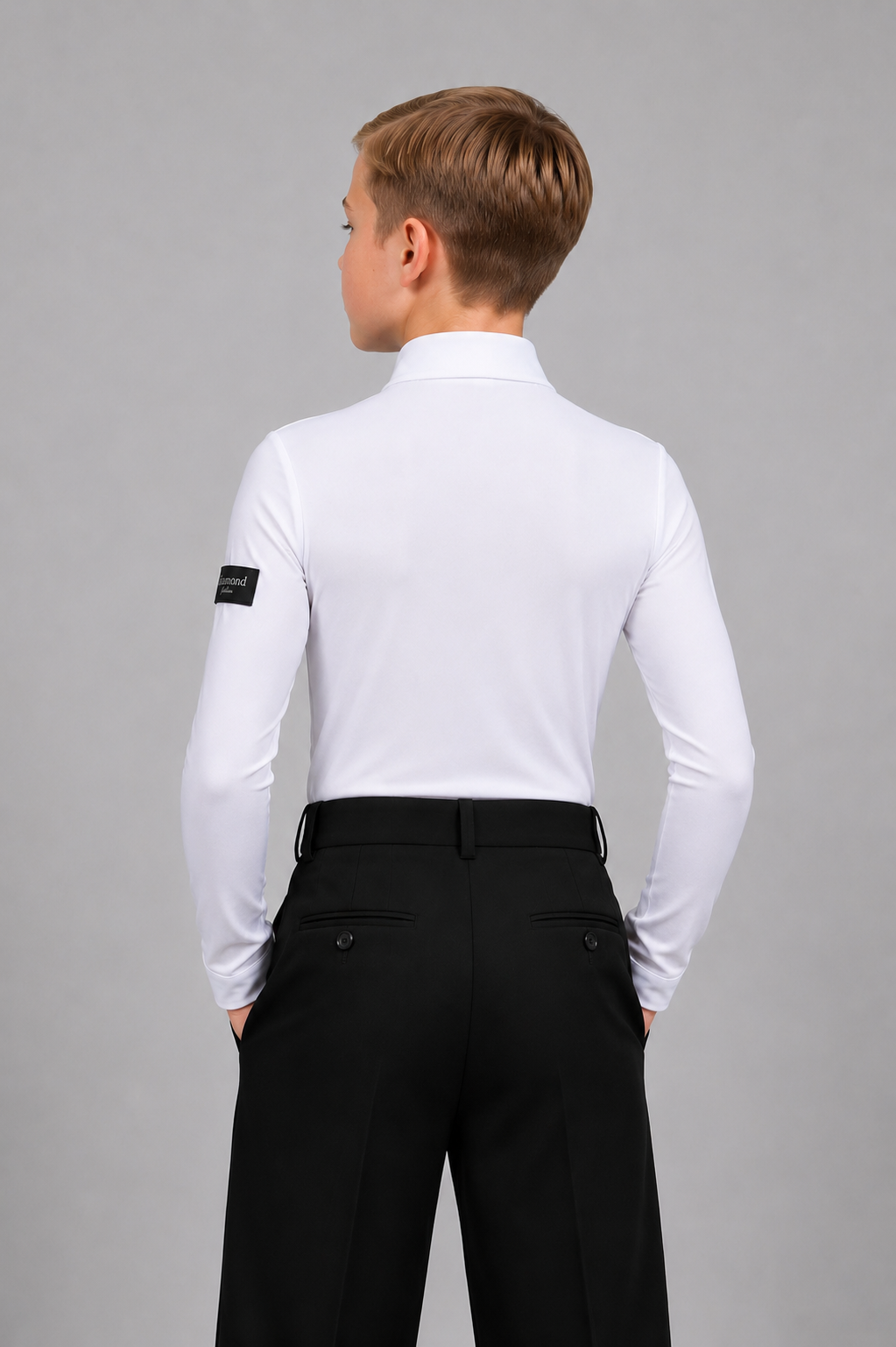 Back view of a boy wearing a fitted white Standard Ballroom dance shirt with black trousers, designed for competitions and dance training