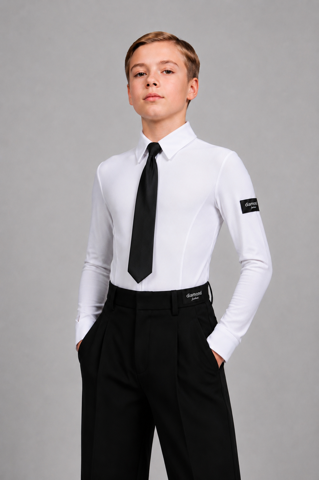 Boy wearing a white Standard Ballroom dance shirt bodysuit with a black tie and black trousers, designed for ballroom competitions and dance training.