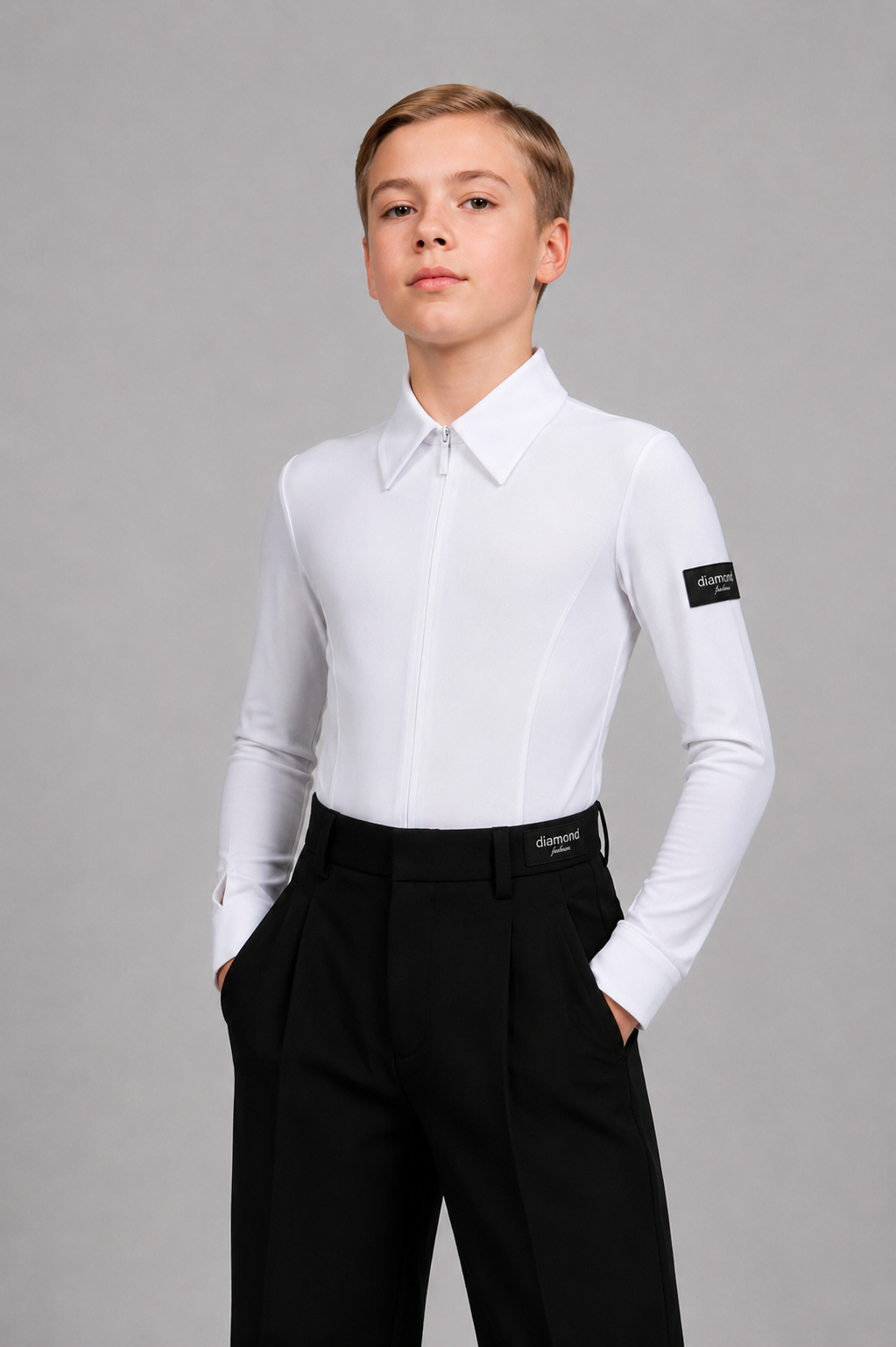 Front view of a boy wearing a fitted white Standard Ballroom dance shirt with a hidden front zipper and black ballroom trousers, designed for competitions and dance training