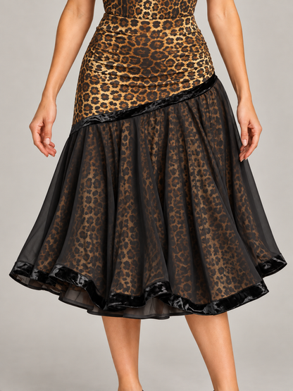 Leopard print dance skirt with a fitted waistband, sheer black overlay, one lining and black velvet trim, shown close up on a model.