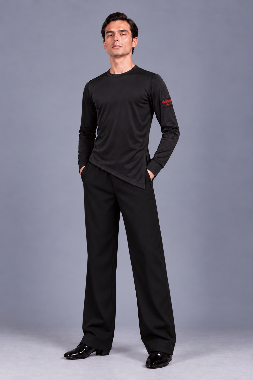 Front view of Diamond Fashion men’s black wide-leg Latin and ballroom dance trousers, styled with an asymmetric long-sleeve dance top.