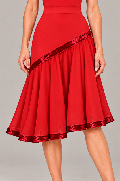 Close-up of a red ballroom and Latin practice skirt with velvet trim, a flowing lined lower section and a slightly asymmetric hem.