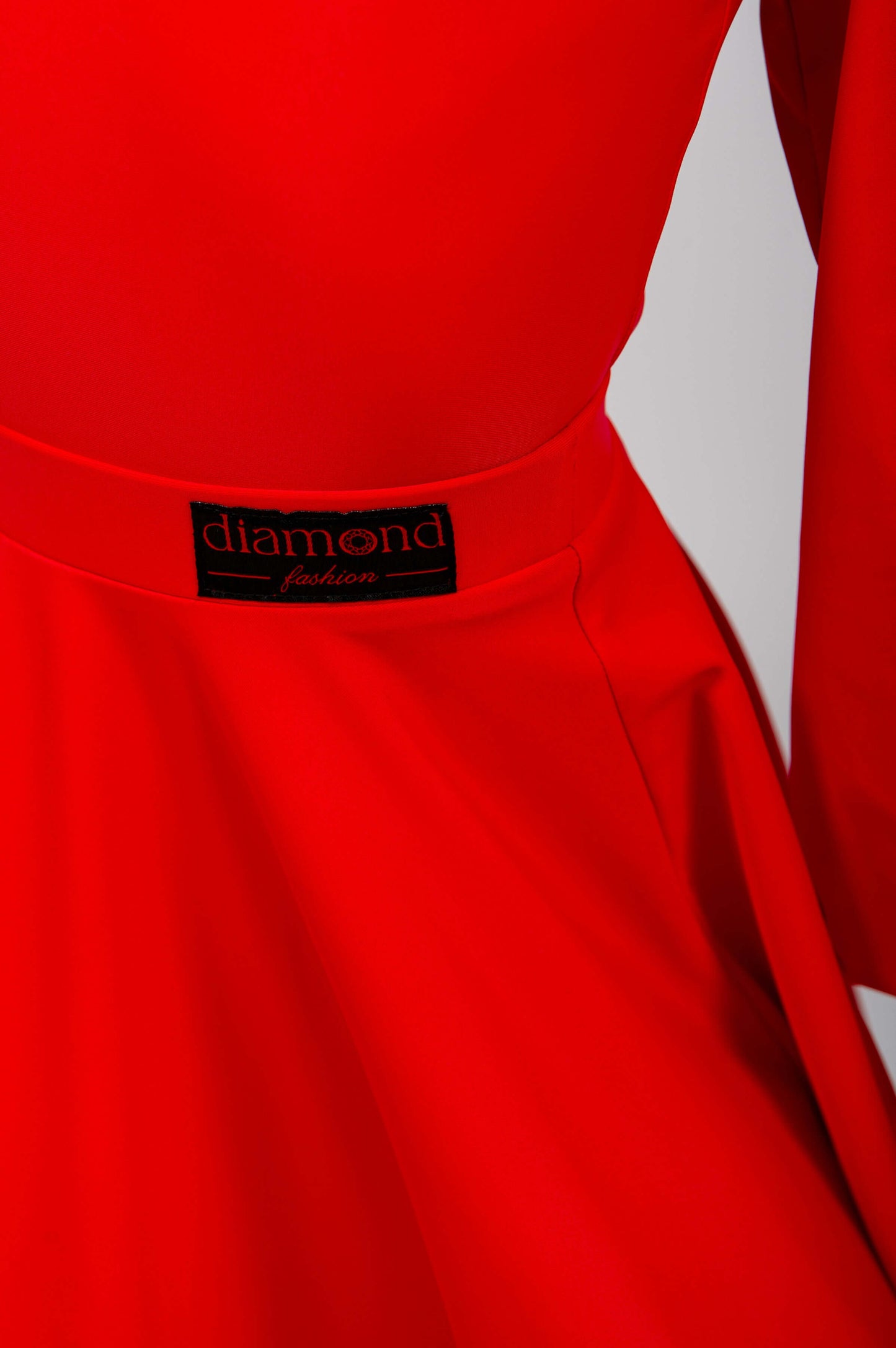 girl wearing a red dress posing against a plain background Juvenile ballroom competition dance set with bodysuit and knee-length 360 circle skirt in red, WDSF approved, suitable for Latin and Standard