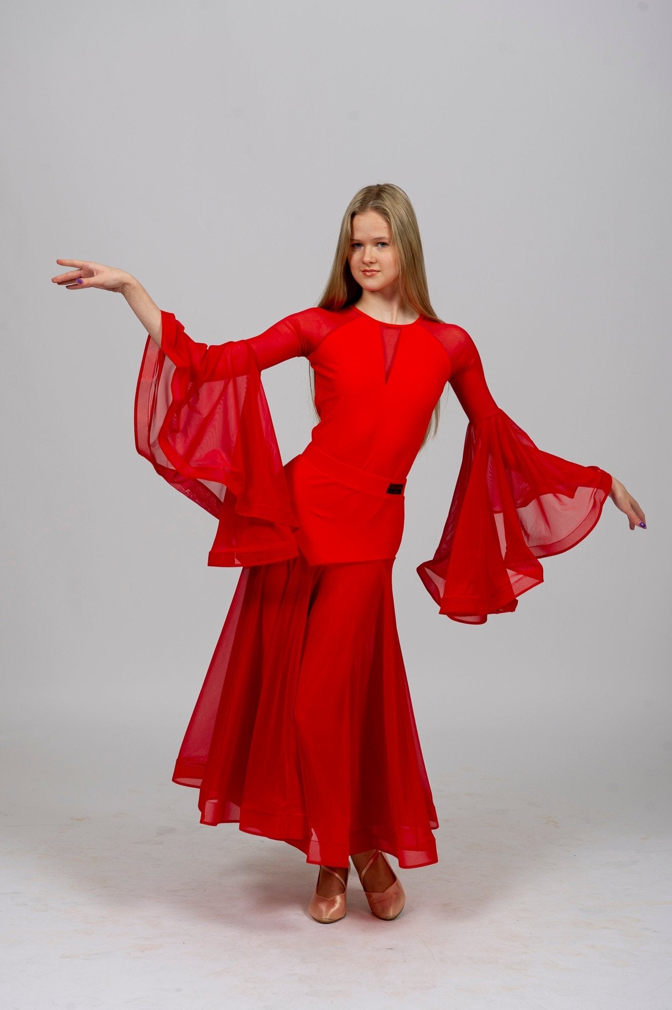 Model showcasing a graceful dance bodysuit in vibrant red with flowing sleeves, perfect for standard dance performances.